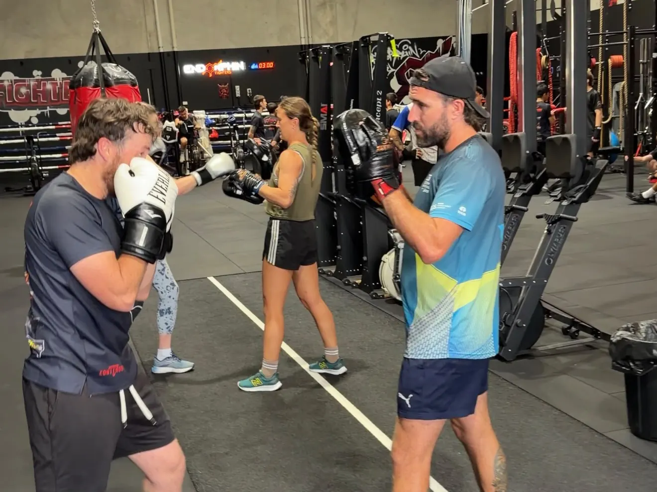 Members doing box jumps and bag work